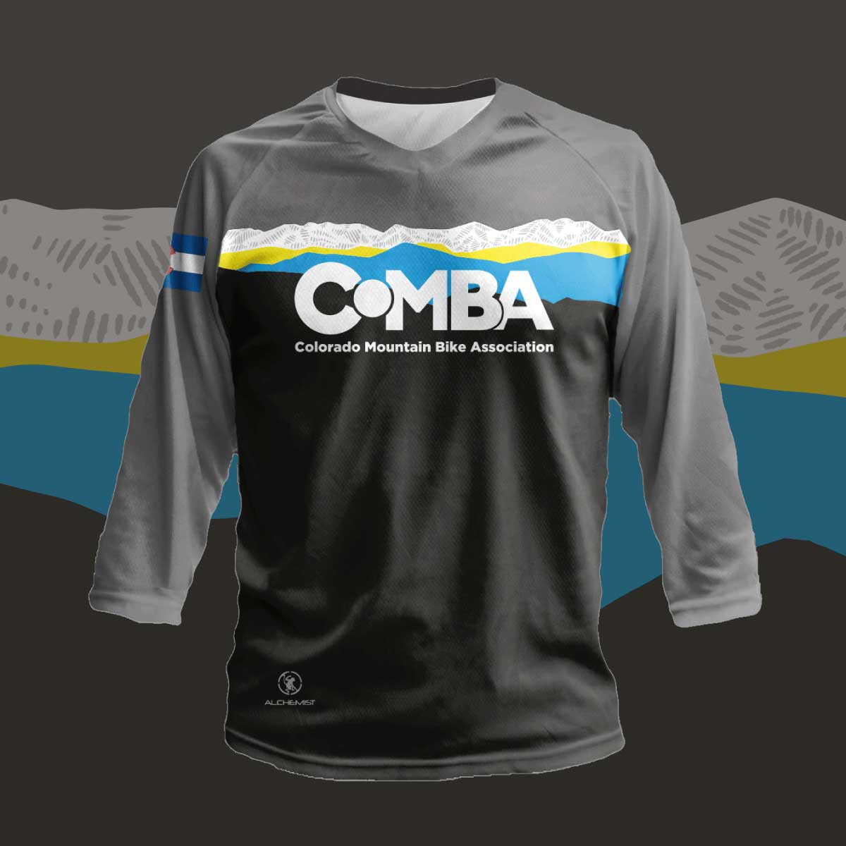 A black and grey MTB jersey with COMBA's logo and an illustration of the Front Range