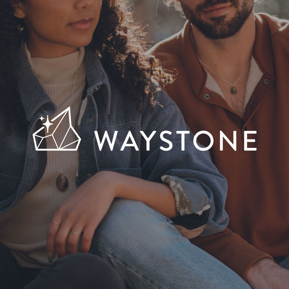 The Waystone logo with two models wearing stone jewelry